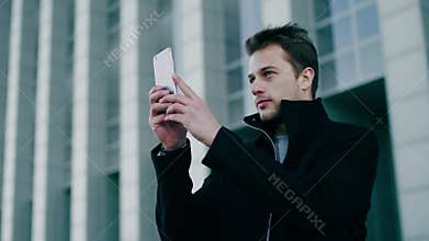 Architect male makes panorama of new buildings