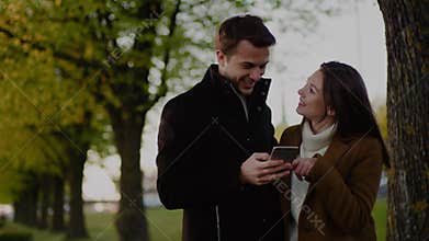 Positive Couple Watch Photos Together .