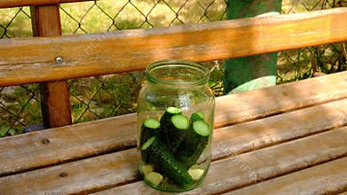 The process of canning pickles, put cucumbers in an empty jar