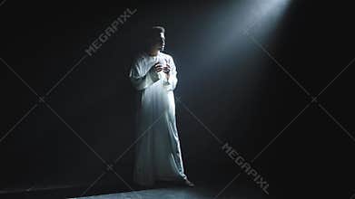 A young African American man in a white hoodie looks at the beam of light in dismay and says wow with a shocked