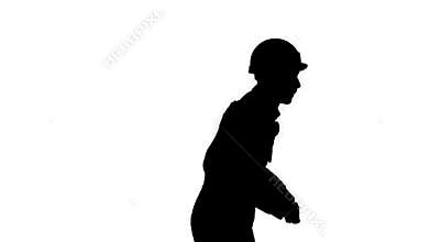 Silhouette Young construction worker in hard hat dancing hip-hop.