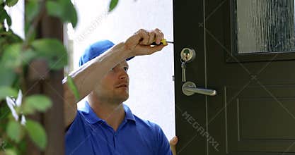 Locksmith service - man repairing house door lock
