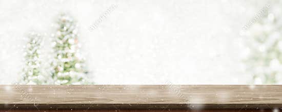 Christmas wood table top at blur bokeh christmas tree decor with string light background,Winter holiday greeting card