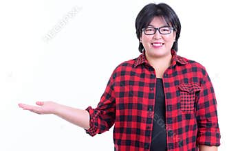 Happy overweight Asian hipster woman showing something