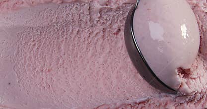 Top view of strawberry flavour ice cream with scoop