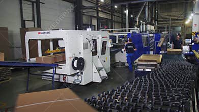 Production line ties and transports paper piles in shop