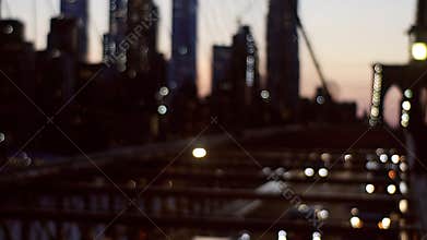 Brooklyn Bridge at night time with car traffic view from above of the busy roads of New York soft focus
