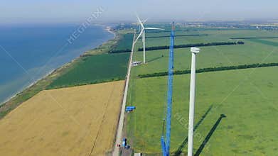 Aerial footage of the wind farm and the construction site of a wind turbine