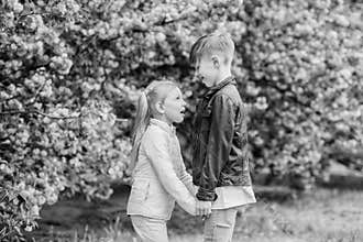 Love is in the air. Tender love feelings. Little girl and boy. Romantic date in park. Spring time to fall in love. Kids