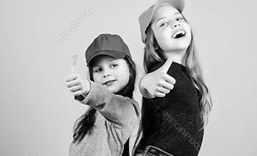 Cool girls. Little cute girls wearing bright baseball caps. Modern fashion. Hats and caps. Stylish accessory. Kids