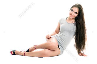 Smiling pretty young woman in gray dress