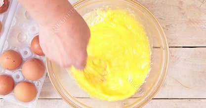 Mixing grated pecorino cheese to beaten eggs
