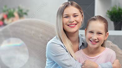 Happy young mother and teen daughter laughing having positive emotion feeling love