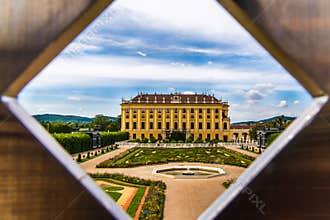 Diamond shaped hole view of majestic Schonbrunn palace, Vienna Austria