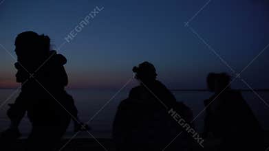 Refugee family running at night, escaping border control, illegal migration