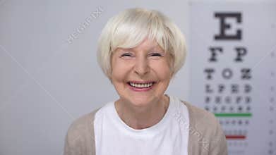 Senior woman smiling after successful cataract removal surgery, focused vision