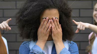 Depressed african american girl crying, victim of racial bullying at school