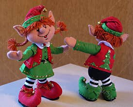 Felt decoration in retro style - dansing christmas elves. Cute close-up of christmas toys. Happy new year hand made