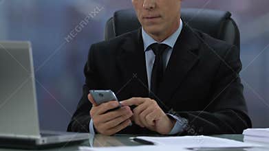 Male boss in formal suit checking meeting calendar in smartphone, business app