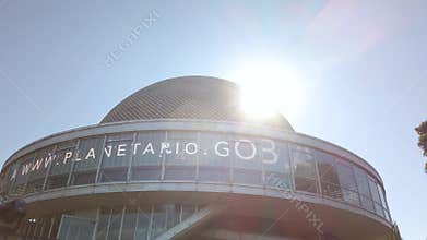 Cinematic sun flare over Galileo Galilei planetarium dome in Buenos Aires