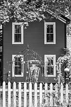 Monochrome House with White Picket Fence
