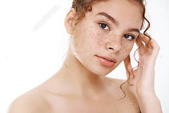 Beauty, skincare concept. Tender redhead young woman naked freckles look camera sensually gently touching pure clean