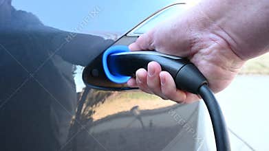 Plugging in charge cable of an electric car