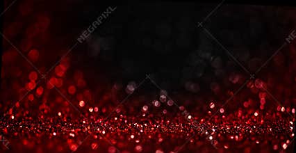 Abstract blur red glitter on black background. Card for Valentine`s day, christmas and wedding celebration. Love bokeh sparkle