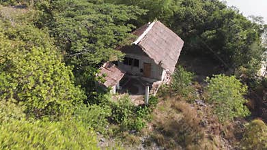 Panoramic view of an old abandoned house in the jungle on a cliff.