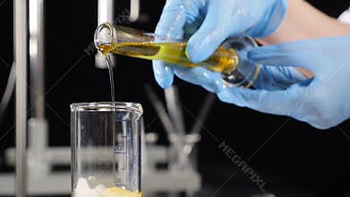 Cosmetics manufacturing industry. natural organic ingredients. Close-up of scientist in gloves testing variety of