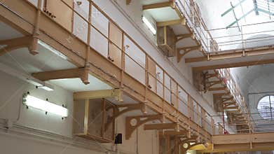 Metal balconies with steel doors of prison cells, bottom view