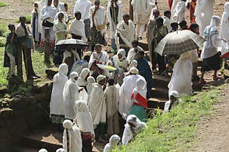 A woman gives some food to parishioners at the end of a religious ceremony in Lalibela. Ethiopia.
