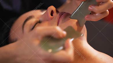Spa woman facial Massage. Face Massage in beauty spa salon. Female enjoying relaxing face massage in cosmetology spa