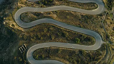 Professional road cyclists descend mountain road