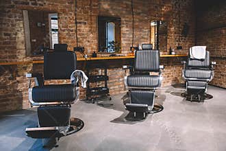 Barbershop armchair, barber shop for men. Empty chairs in retro styled barbershop. Hair salon interior. Place for text or