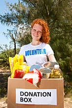 Volunteer carrying food donation box