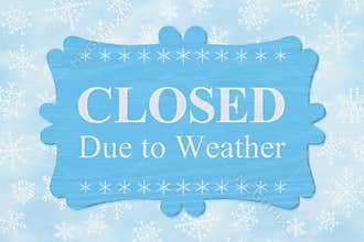 Closed Due to Weather message on a wood sign