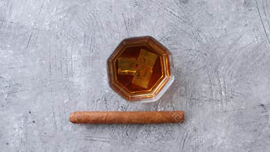 Whiskey or brandy in a glass with Cuban cigar
