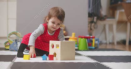 Toddler playing with wooden toy blocks.