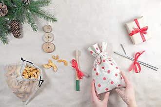 Zero waste plastic free christmas gift flatlay. Reusable produce bag with healthy snack, metal straws, bamboo toothbrush, eco-