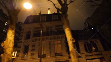 Haussmannian buildings and Eiffel Tower seen through the buildings