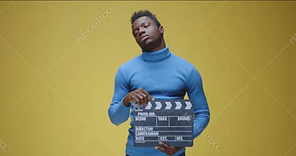 Bored man using film clap