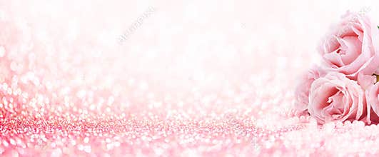 Pink roses bouquet and pearls on abstract blur pastel background. Wedding flowers and bright bokeh glitter backdrop