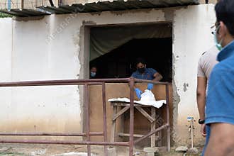 People in masks serving food to underprivileged people like maids, drivers, house cleaners etc during the coronavirus