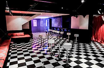 Empty Bar at Night Club with chairs, tables and checkered floors
