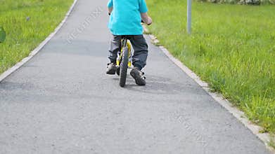 First ride of little boy on balance bike
