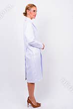 Full body shot profile view of blonde woman doctor as scientist