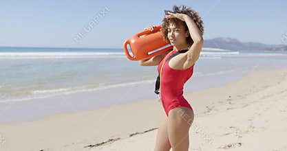 Female lifeguard looking into distance on beach