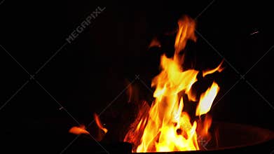 Flames from camp fire on black background