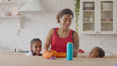Happy family having fun during cleanup in kitchen